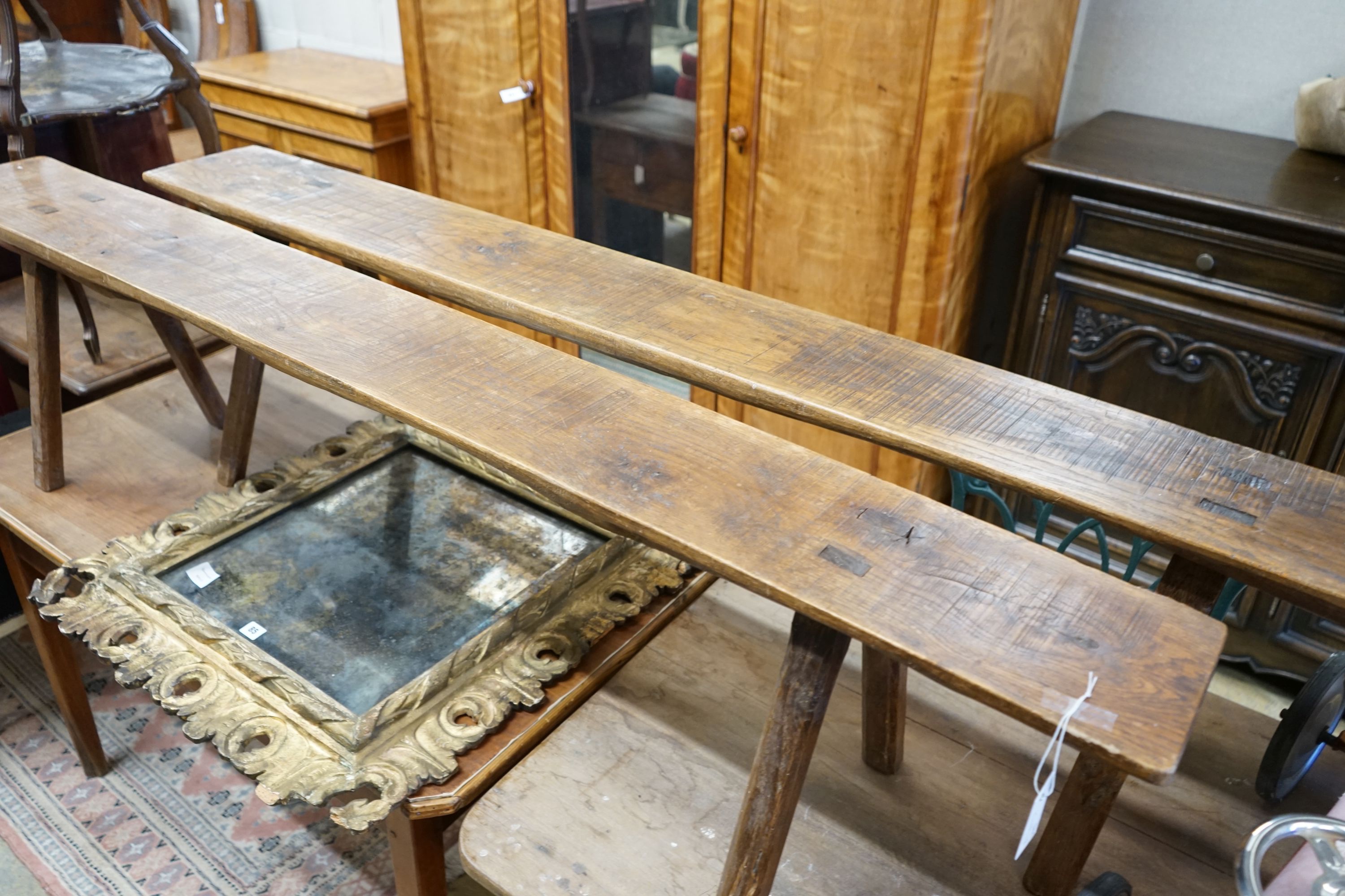 A pair of French provinical oak benches, length 194cm, height 45cm, width 21.5cm